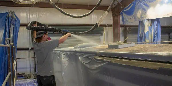 spraying RV roof with specialized chemicals created in house