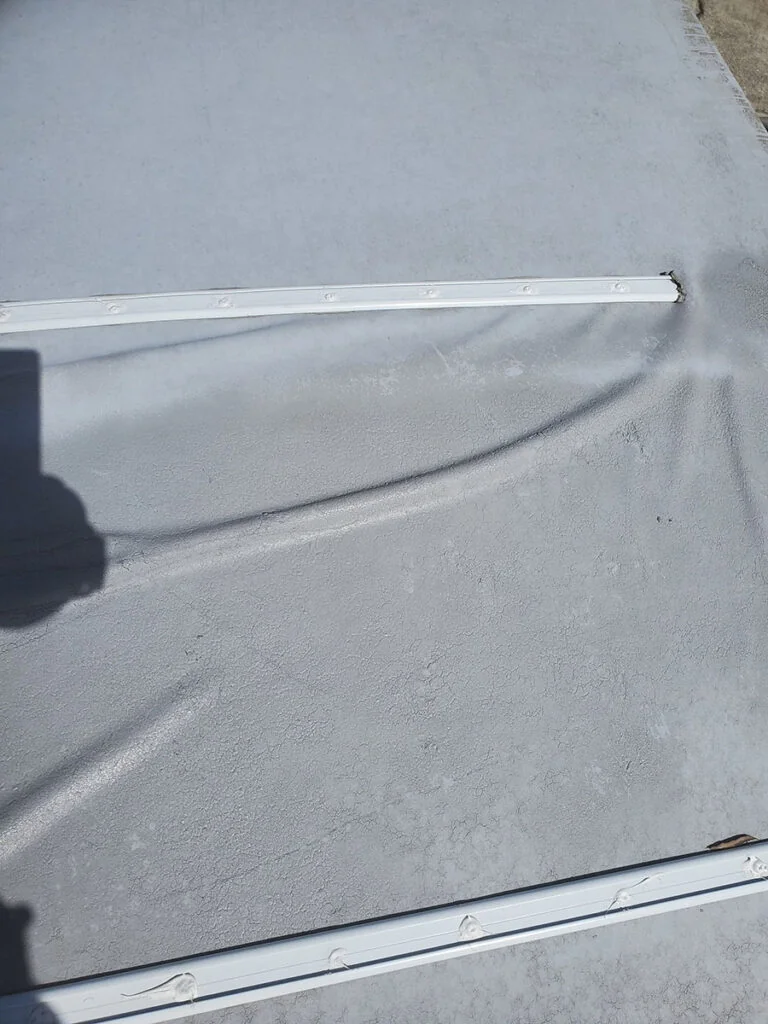 rv roof damage showing wrinkles due to rv roof bubbles