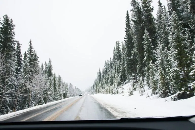 Car driving on a highway in the snowy mountains